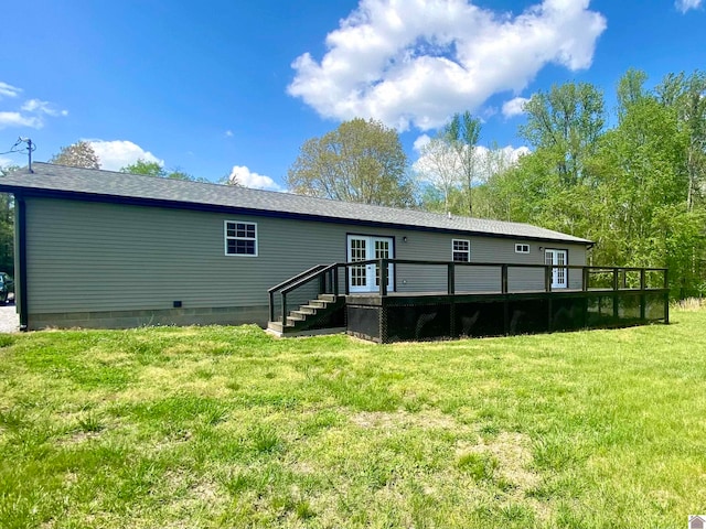 rear view of property with a lawn