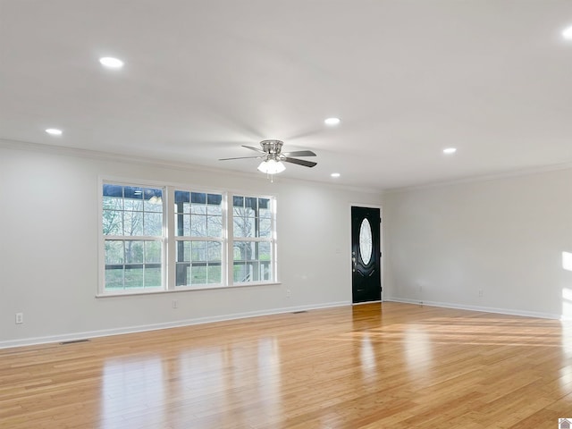 unfurnished room featuring crown molding, light hardwood / wood-style floors, and ceiling fan