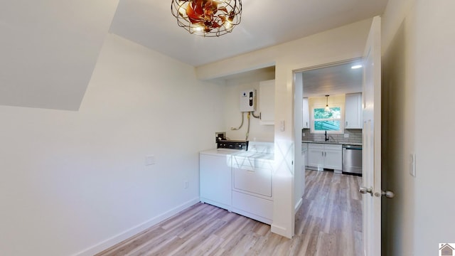 interior space with stainless steel dishwasher, white cabinets, independent washer and dryer, and light hardwood / wood-style floors