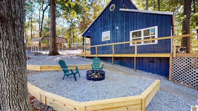 view of yard with a wooden deck and an outdoor fire pit