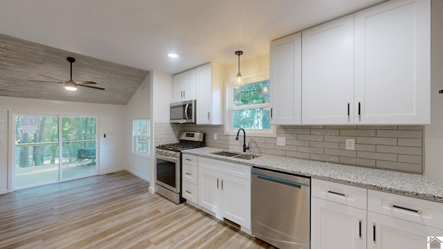 kitchen with white cabinetry, light hardwood / wood-style floors, appliances with stainless steel finishes, and sink