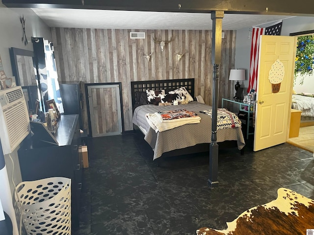 bedroom featuring wood walls