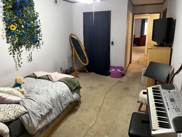 bedroom with crown molding and carpet flooring