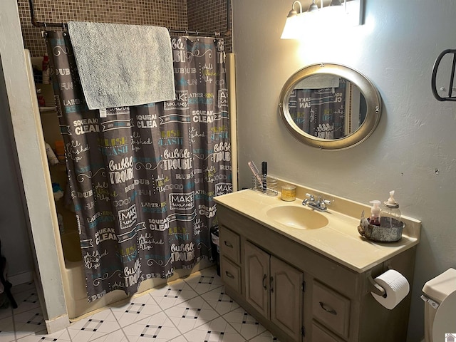 bathroom featuring vanity, toilet, and tile patterned flooring