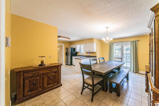 9618 Scale Rd, Benton, KY 42025 - dining room with a textured ceiling, a notable chandelier, and light tile patterned flooring