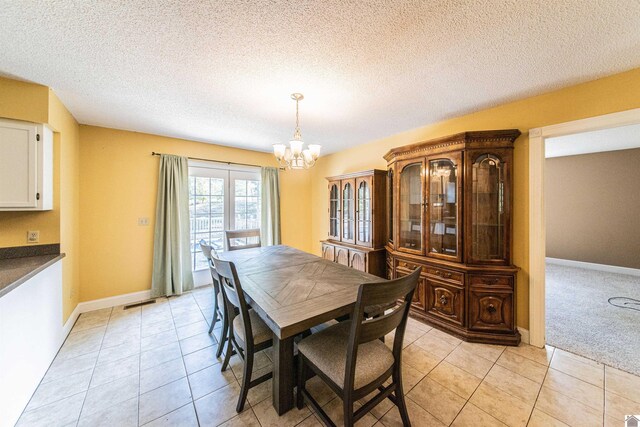 9618 Scale Rd, Benton, KY 42025 - dining room with baseboards, a textured ceiling, a notable chandelier, and light tile patterned floors