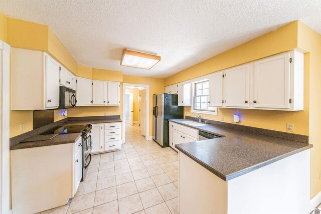 9618 Scale Rd, Benton, KY 42025 - kitchen with dark countertops, stainless steel electric range, black microwave, a peninsula, and refrigerator with ice dispenser