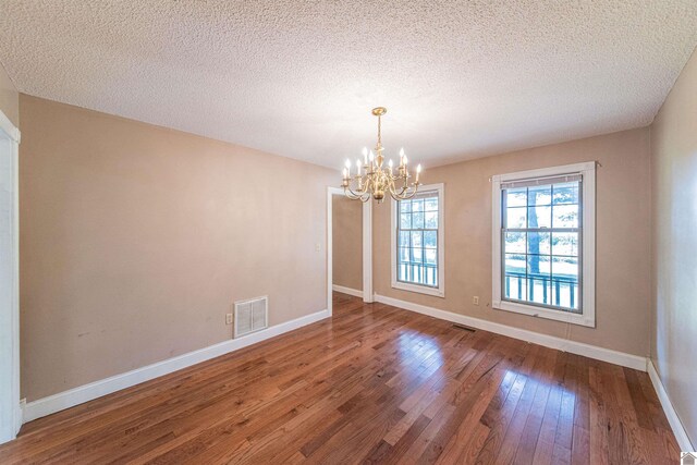 9618 Scale Rd, Benton, KY 42025 - unfurnished dining area featuring hardwood / wood-style floors, baseboards, visible vents, and a chandelier