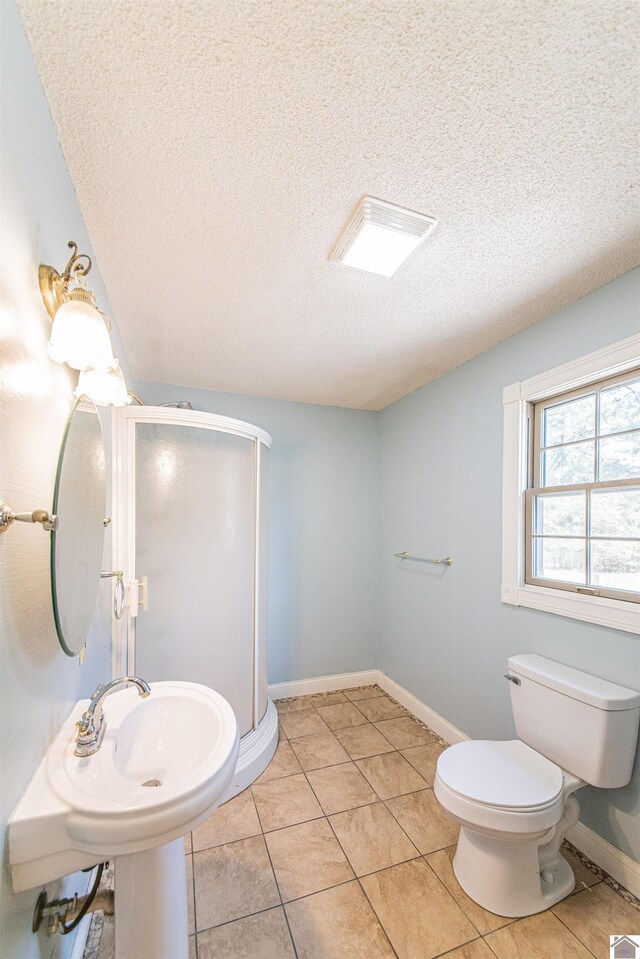 9618 Scale Rd, Benton, KY 42025 - full bathroom with a textured ceiling, toilet, baseboards, tile patterned flooring, and a shower stall