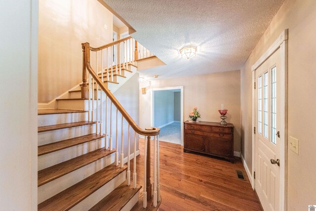 9618 Scale Rd, Benton, KY 42025 - foyer featuring visible vents, wood finished floors, a textured ceiling, and stairs
