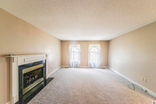 9618 Scale Rd, Benton, KY 42025 - unfurnished living room with a premium fireplace, a textured ceiling, carpet flooring, and baseboards