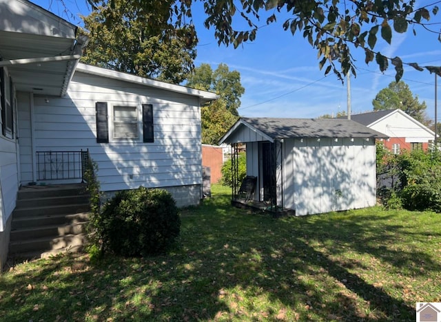 view of property exterior featuring a storage shed and a lawn