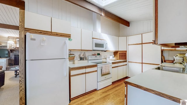 kitchen with beam ceiling, white cabinetry, light hardwood / wood-style flooring, sink, and white appliances