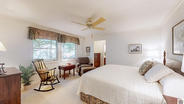 carpeted bedroom with ornamental molding and ceiling fan