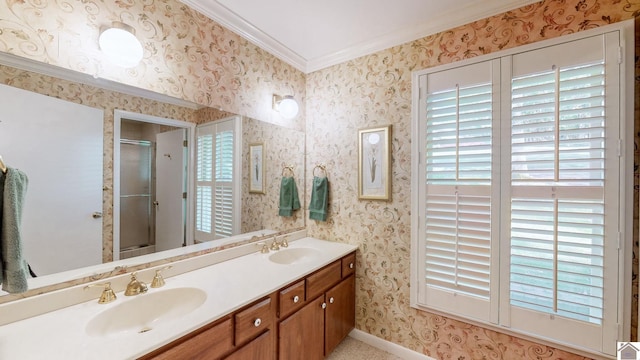 bathroom with a shower with door, crown molding, and vanity