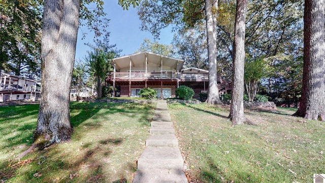 view of front of property featuring a front lawn and a deck