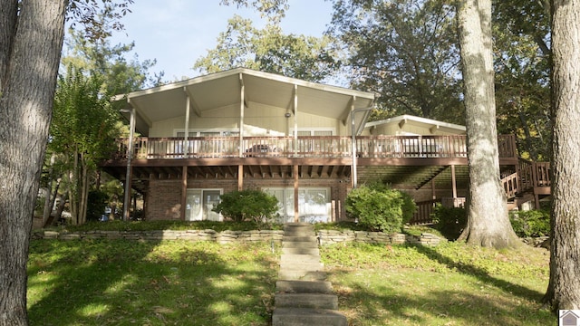 back of house with a wooden deck and a yard