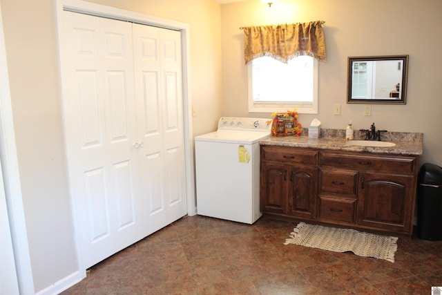 washroom with washer / clothes dryer, sink, and cabinets