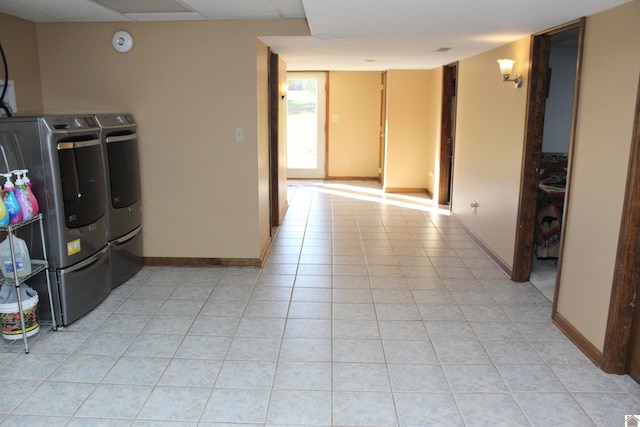 washroom with washing machine and dryer and light tile patterned floors