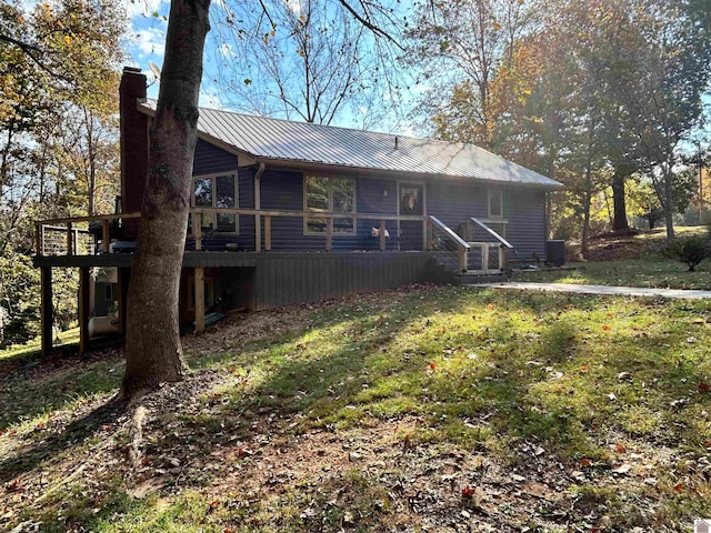 back of house featuring a yard and a wooden deck