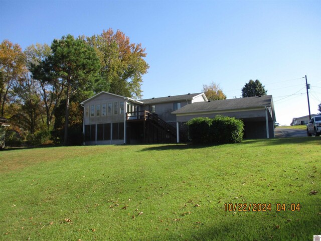 view of front of house with a front yard and a sunroom