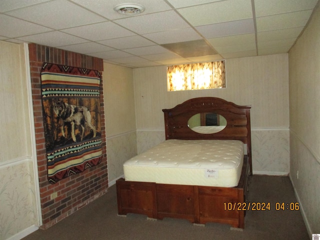 bedroom featuring a paneled ceiling and carpet flooring