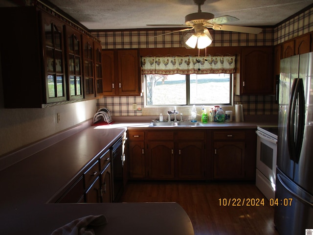 kitchen featuring decorative backsplash, dark wood-type flooring, sink, white range with electric cooktop, and stainless steel refrigerator