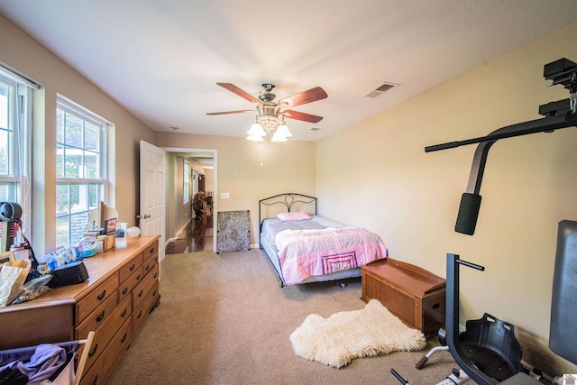 bedroom with light colored carpet and ceiling fan