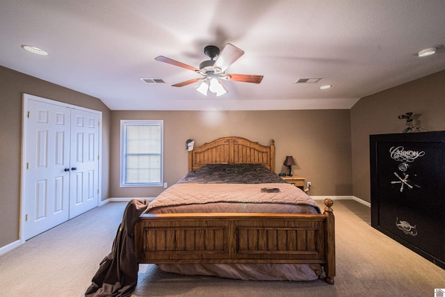 bedroom featuring vaulted ceiling, carpet flooring, a closet, and ceiling fan