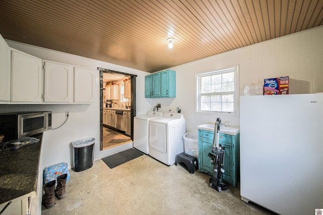 laundry area with wood ceiling, washer and dryer, and cabinets