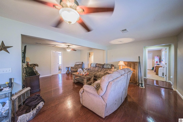 living room featuring dark hardwood / wood-style floors and ceiling fan