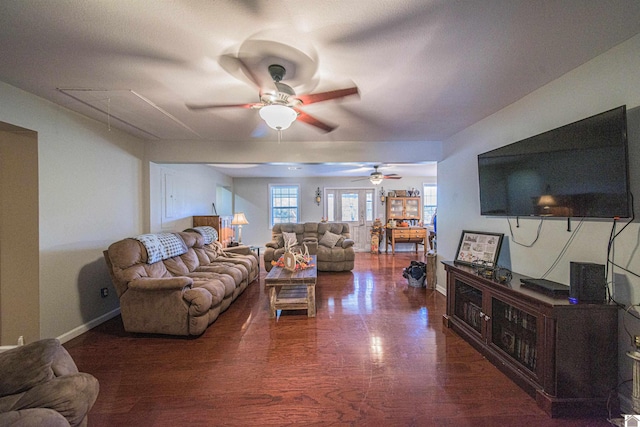 living room featuring dark hardwood / wood-style floors and ceiling fan