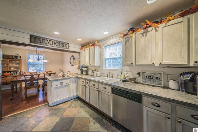 kitchen with sink, dishwasher, a textured ceiling, kitchen peninsula, and pendant lighting