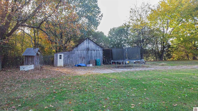 view of yard with a storage shed and a trampoline