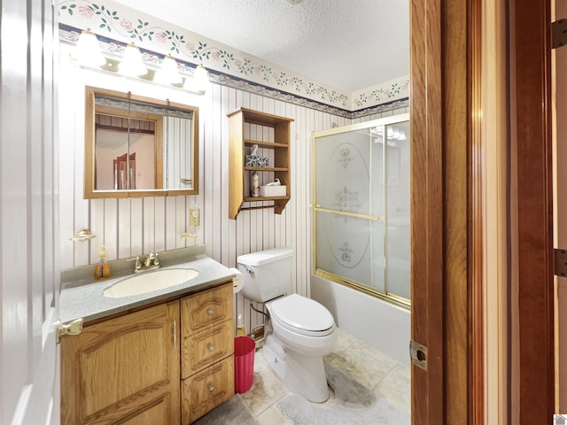 full bath featuring vanity, toilet, a textured ceiling, enclosed tub / shower combo, and tile patterned floors