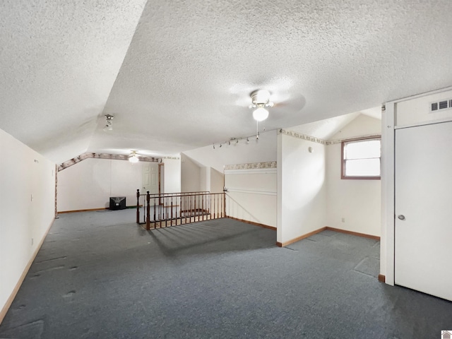bonus room featuring visible vents, carpet floors, lofted ceiling, baseboards, and ceiling fan