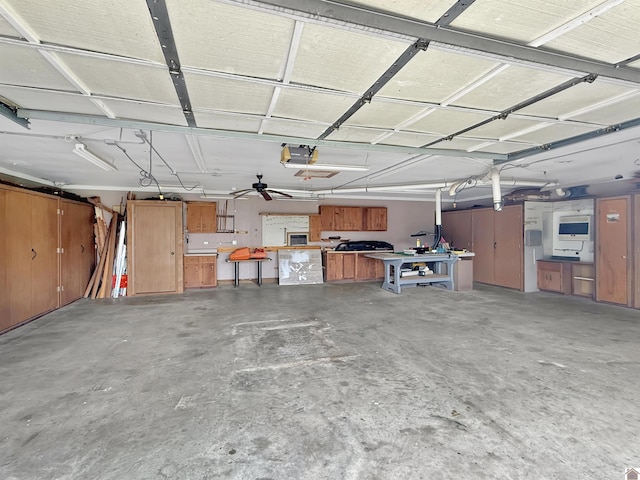 garage with a workshop area and a garage door opener