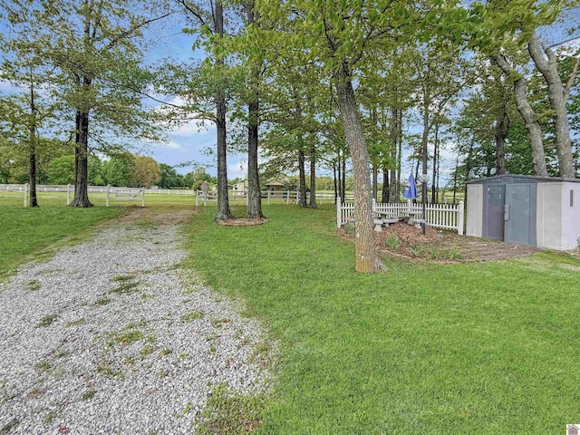 view of yard with fence and an outdoor structure