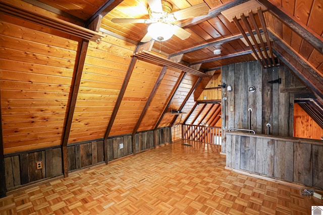 bonus room with wood ceiling, lofted ceiling with beams, and wooden walls