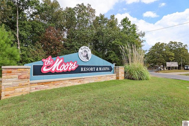 community / neighborhood sign with a lawn