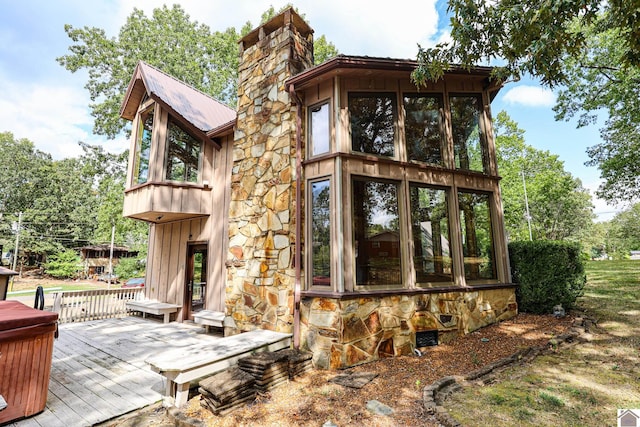 exterior space with a wooden deck and a sunroom