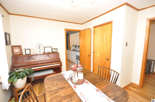 dining room with crown molding and light wood-type flooring