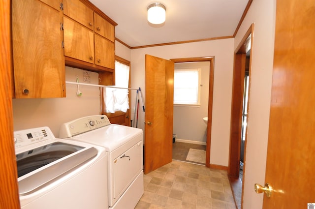 laundry room featuring cabinets, crown molding, and separate washer and dryer