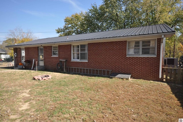 rear view of property with a yard