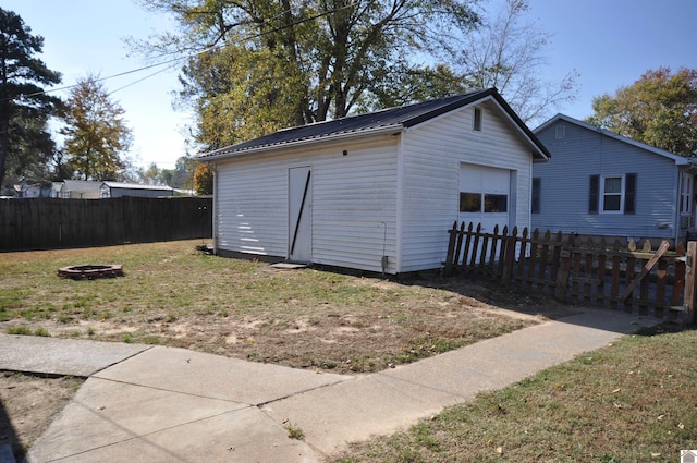 exterior space featuring a fire pit and a lawn