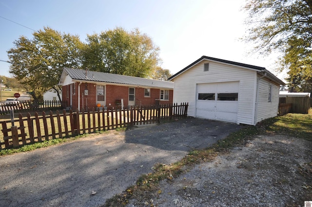 view of front of home with a garage and an outdoor structure