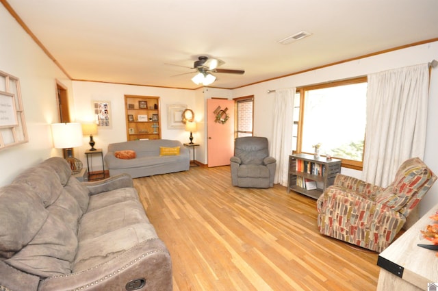 living room featuring crown molding, light hardwood / wood-style flooring, and ceiling fan