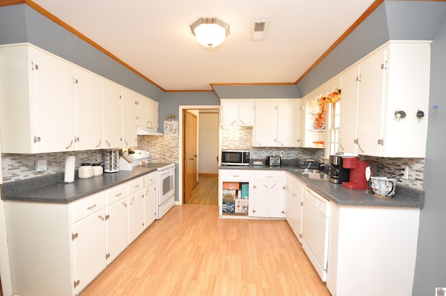 kitchen with white appliances, backsplash, white cabinetry, and light hardwood / wood-style flooring