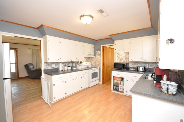 kitchen featuring white appliances, light hardwood / wood-style flooring, and white cabinets