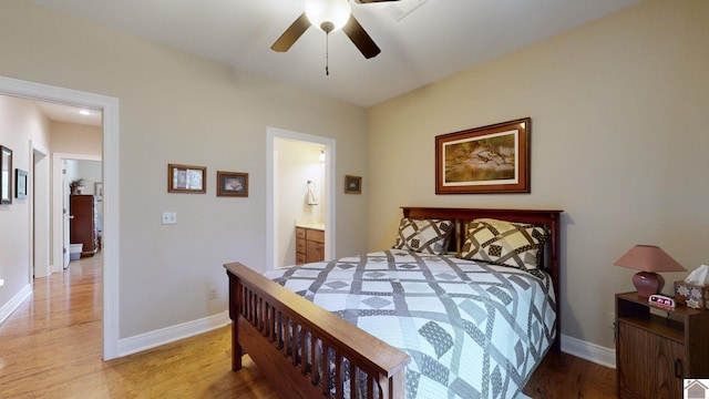 bedroom with ensuite bath, wood-type flooring, and ceiling fan